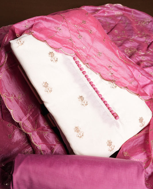 White colour churidhar material featuring thread embroidery on the front panel, contrast Pink colour dupatta with elegant border, and matching plain bottom