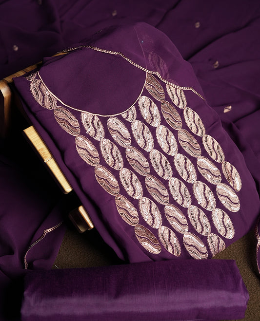 Dark violet colour churidar material adorned with intricate sequin embroidery on the neckline and body & Accompanied by a matching embroidered dupatta and plain bottom.
