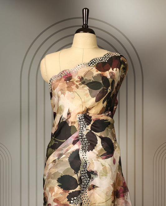 Beige colour pure crepe saree with abstract floral print in earthy tones, highlighted by mirror work on the body and scalloped border, paired with a matching blouse.