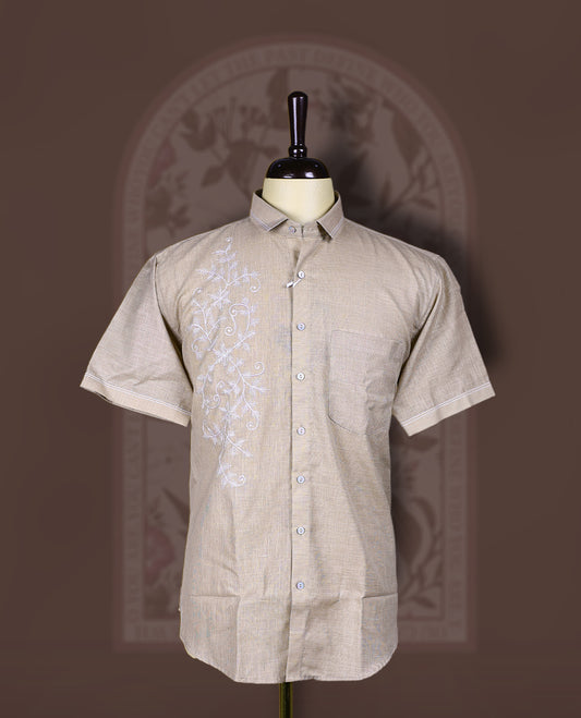 Taupe cotton linen short sleeve shirt featuring intricate white floral vine embroidery on the front, Designed with a mandarin collar and button-down style, blending artisanal detail with modern elegance.