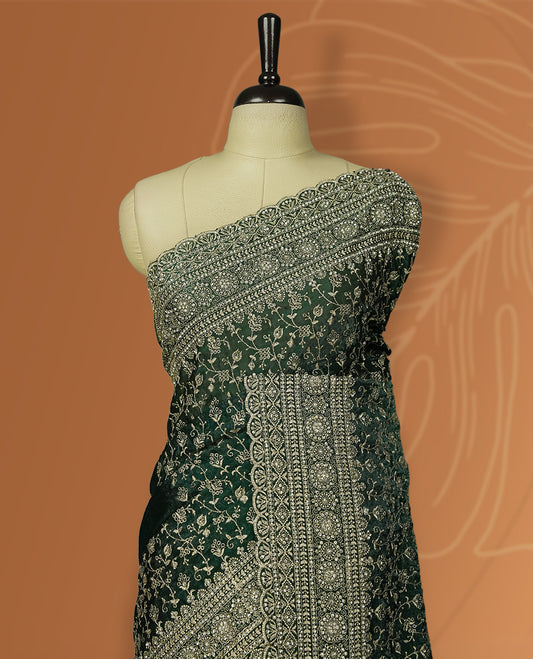 Royal Green colour velvet chiffon designer saree in elegant two tone shades, featuring light gold zari, kodi work with handwoven style thread aari & dori embroidery work, Swarovski stone work and all over motifs, comes with matching blouse.