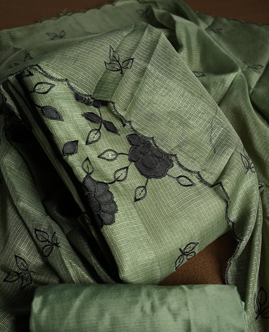 Olive colour churidhar material featuring Black colour thread embroidery on the front panel, self colour dupatta with elegant border, and matching plain bottom