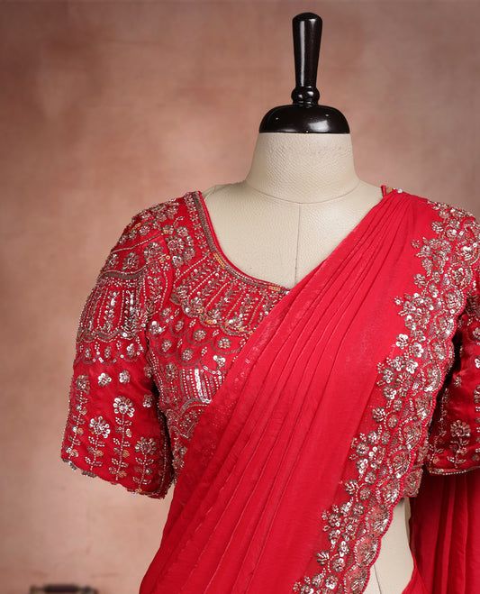 Elegant Deep Red ready to wear saree adorned with rich silver zari and bead embroidery along the border and pallu, paired with a heavily embellished matching blouse for a grand festive look.