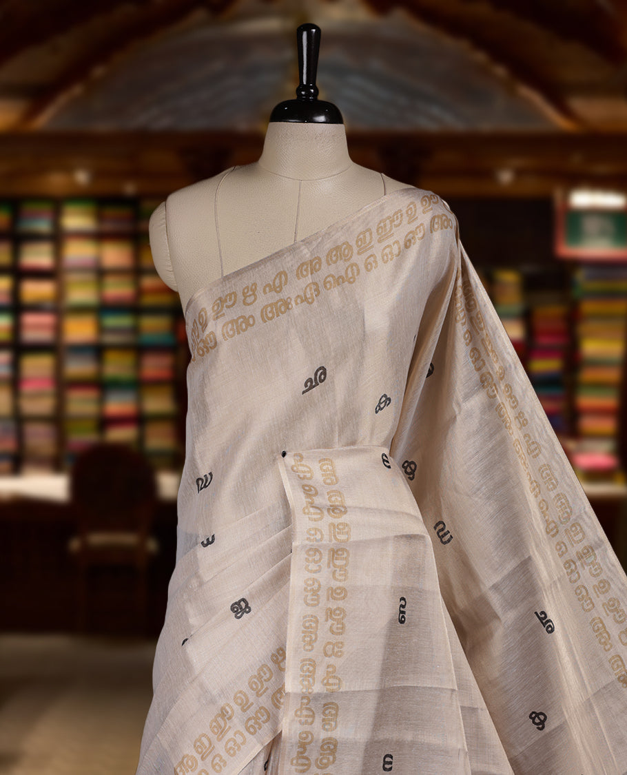 Beige colour Semi tissue saree adorned with Contrast colour digital script Design on the body and an elegant pallu & comes with a matching blouse piece