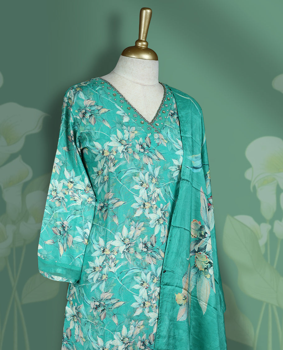 Aqua green colour churidar set featuring elegant white thread embroidery on the neckline, sleeves, and coloured floral pattern across the body, Paired with a matching dupatta