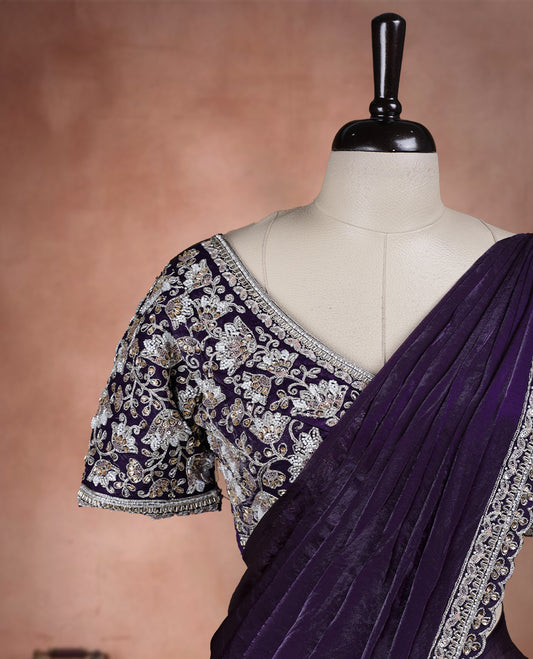 Elegant Royal purple ready to wear saree adorned with rich silver zari and bead embroidery along the border and pallu, paired with a heavily embellished matching blouse for a grand festive look.