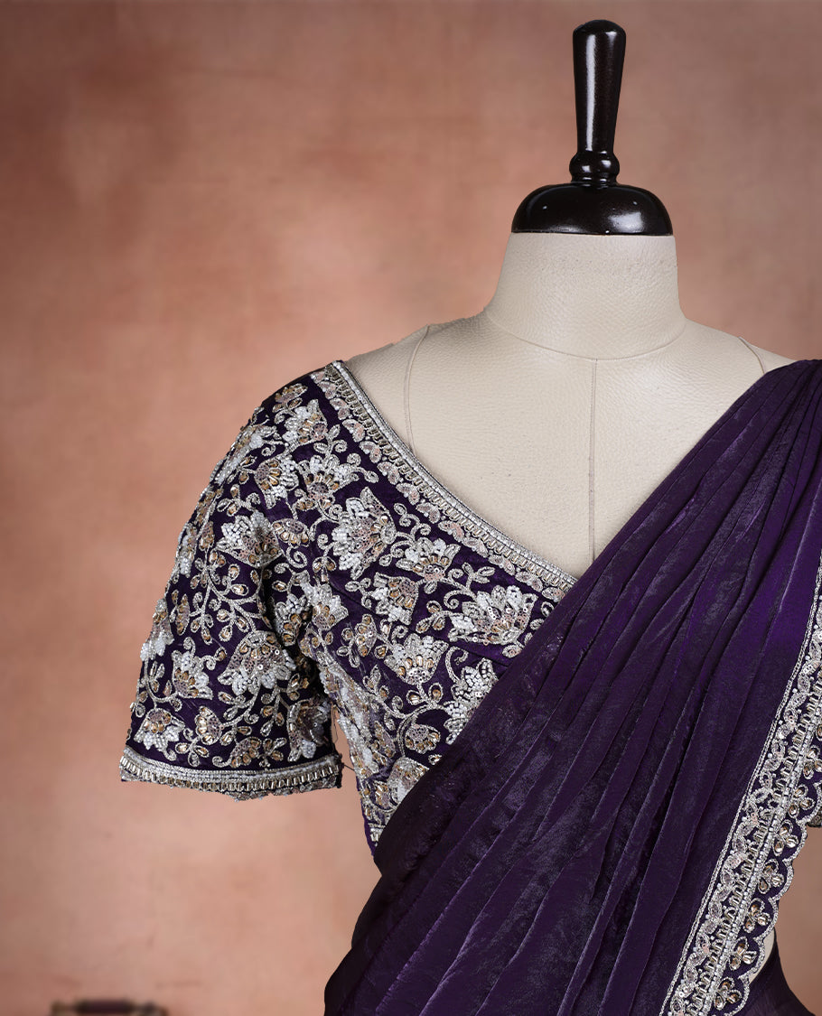 Elegant Royal purple ready to wear saree adorned with rich silver zari and bead embroidery along the border and pallu, paired with a heavily embellished matching blouse for a grand festive look.