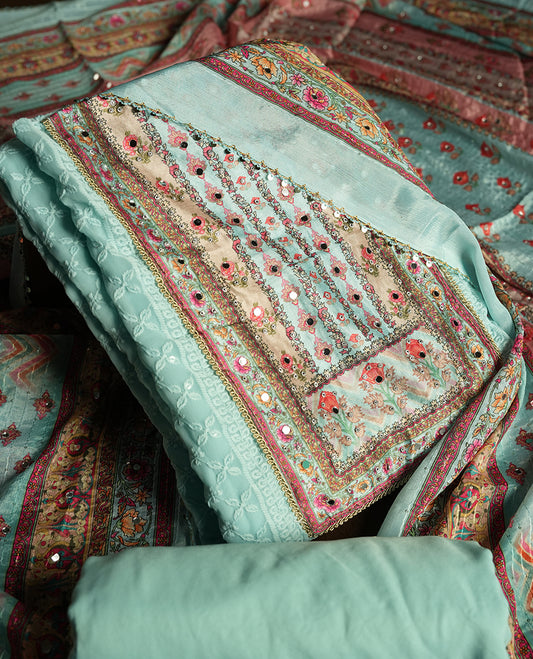 Light Aqua colour churidhar material featuring Mirror and thread embroidery, foral print pattern on the self colour front panel, floral digital printed dupatta with elegant border, and matching plain bottom