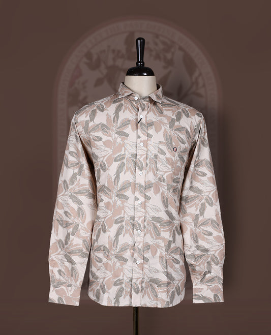 Cream colored shirt in soft cotton, featuring an all over leaf print in subtle earthy tones, Designed with a classic collar and roll up sleeves, it offers a perfect balance of tradition and ease.