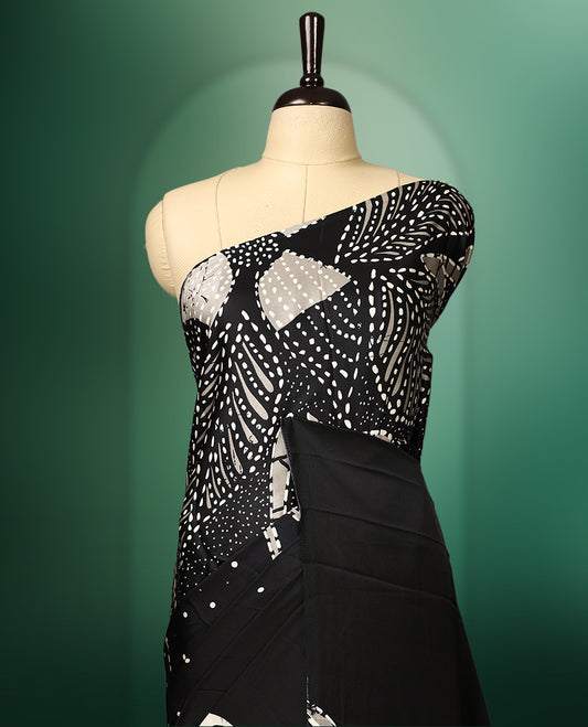 Black and white colour saree featuring abstract patterns with intricate dotted and floral motifs, creating a modern yet graceful look, paired with a matching blouse