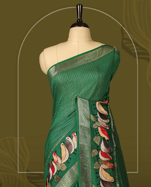 Green viscose saree featuring subtle checkered patterns and a beautifully embroidered bird motif border, paired with a rich pallu & perfect for festive occasions, celebrations, and elegant gatherings.