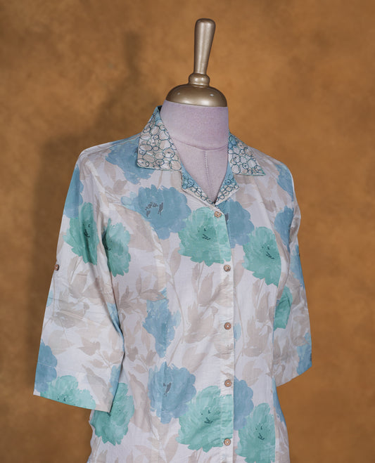 Light blue colour button down kurti BY VISMAY with an all over teal and aqua floral print, straight calf length silhouette, classic shirt collar, and elbow length sleeves.