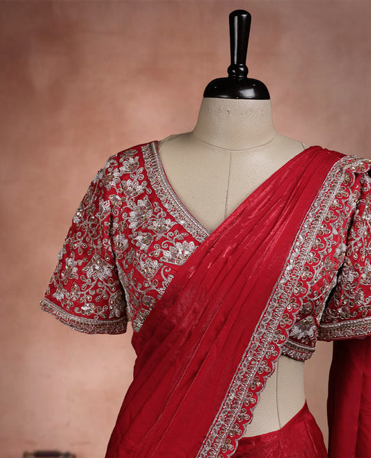Elegant Bright Red Colour ready to wear saree adorned with rich silver zari and bead embroidery along the border and pallu, paired with a heavily embellished matching blouse for a grand festive look.