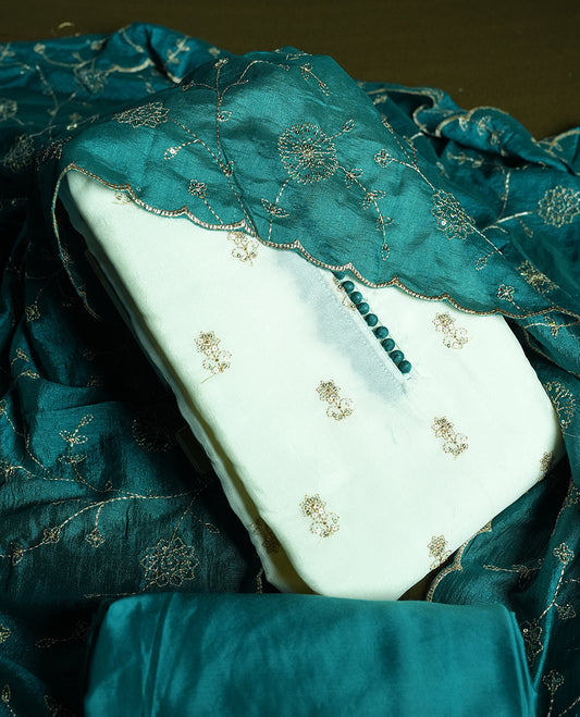 White colour churidhar material featuring thread embroidery on the front panel, contrast Green colour dupatta with elegant border, and matching plain bottom