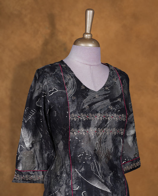 Black colour tie dye kurti BY TALISHA with abstract grey patterns, flared calf length silhouette, round neckline, three quarter sleeves, and contrast piping detail.
