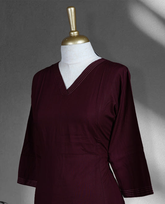 Dark grape colored cord set featuring a plain V neck kurta with subtle stitch detailing on neckline and sleeves, paired with matching palazzo.