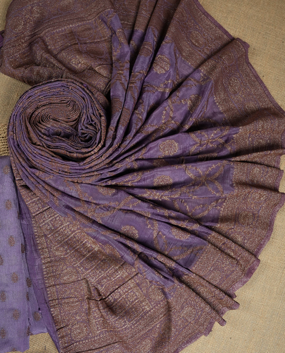 Lavender colour suit material adorned with delicate light copper toned zari work & Comes with a beautifully woven dupatta and matching plain bottom fabric.
