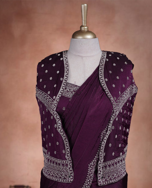 Elegant Wine Colour ready to wear saree adorned with rich silver zari and bead embroidery along the border and pallu, paired with a heavily embellished matching blouse for a grand festive look.