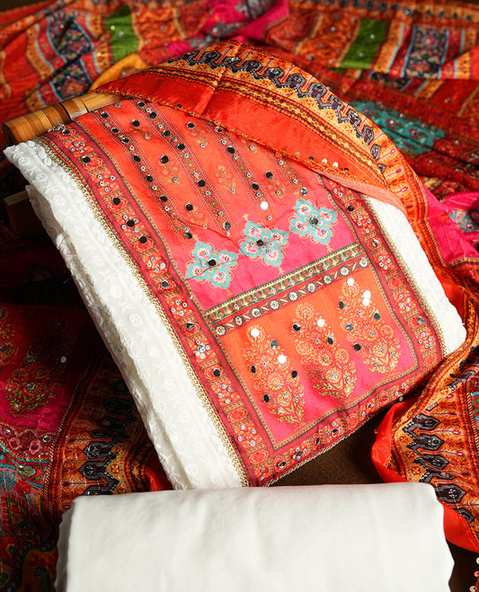 White colour churidhar material featuring Mirror and thread embroidery & foral print pattern on the contrast Dark orange colour  front panel, floral digital printed dupatta with elegant border, and matching plain bottom