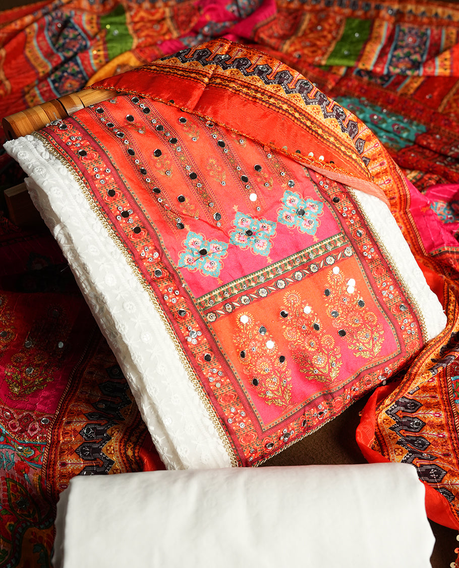 White colour churidhar material featuring Mirror and thread embroidery & foral print pattern on the contrast Dark orange colour  front panel, floral digital printed dupatta with elegant border, and matching plain bottom