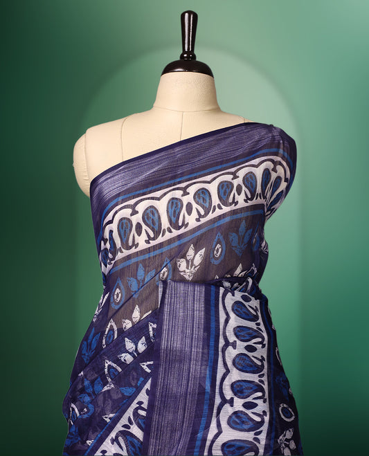 Navy Blue colour cotton saree featuring traditional white and blue hand block prints across the body, highlighted with artistic motifs and a contrasting patterned border, paired with a matching blouse.