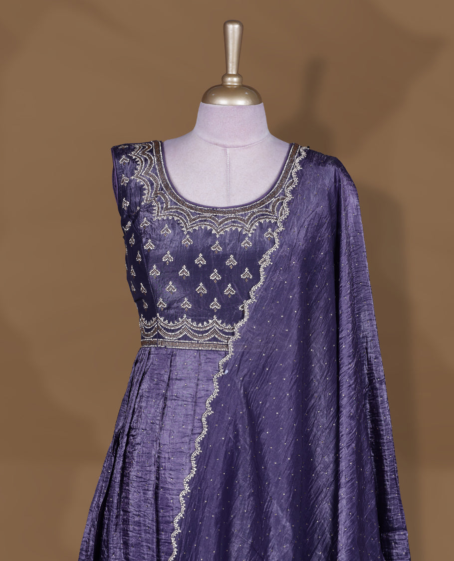 Dark purple colour stitched gown set with sleeveless embroidered yoke, flared ankle‑length silhouette, and attached dupatta featuring dainty butti work and scalloped beaded edging.