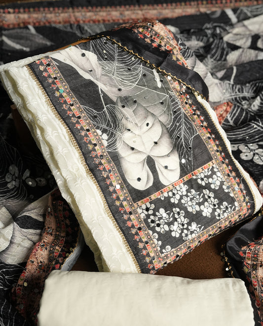 Off white colour churidhar material featuring Mirror and thread embroidery, foral print pattern on the contrast black colour front panel, floral digital printed dupatta with elegant border, and matching plain bottom