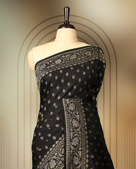 Elegant black Banaras soft silk saree with gold zari buttas on the body, ornate floral zari border, rich woven pallu, and comes with a matching blouse & A timeless drape for festive and formal occasions.