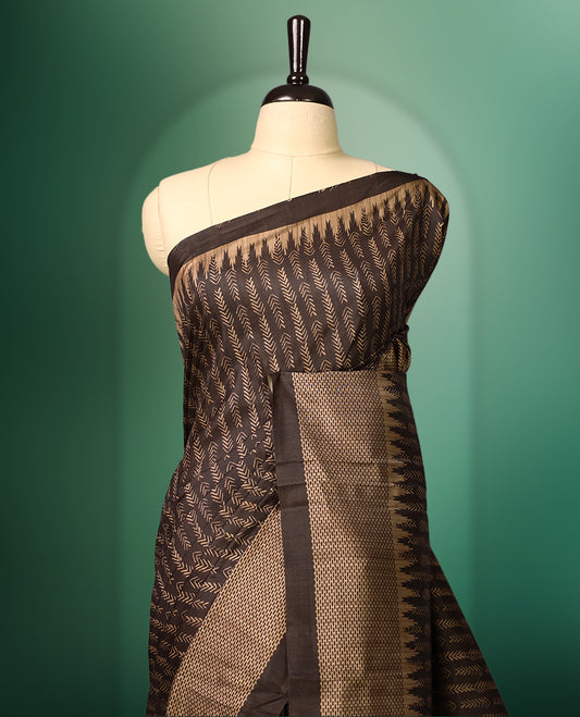 Deep Brown colour saree featuring prints all over the body, complemented by a sleek woven border and pallu, and paired with a matching blouse