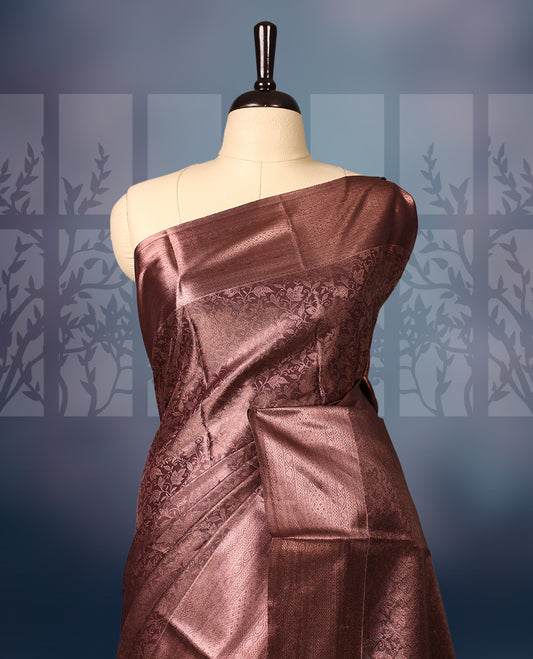 Copper brown semi silk brocade saree adorned with subtle self brocade patterns and a sleek matching woven border and pallu, Comes with a coordinated blouse, perfect for understated traditional elegance.