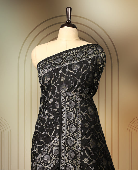 Classic black Banaras soft silk saree adorned with silver zari floral vines, detailed woven border, and grand paisley pallu, Comes with a matching blouse & A regal pick for festive and formal occasions.