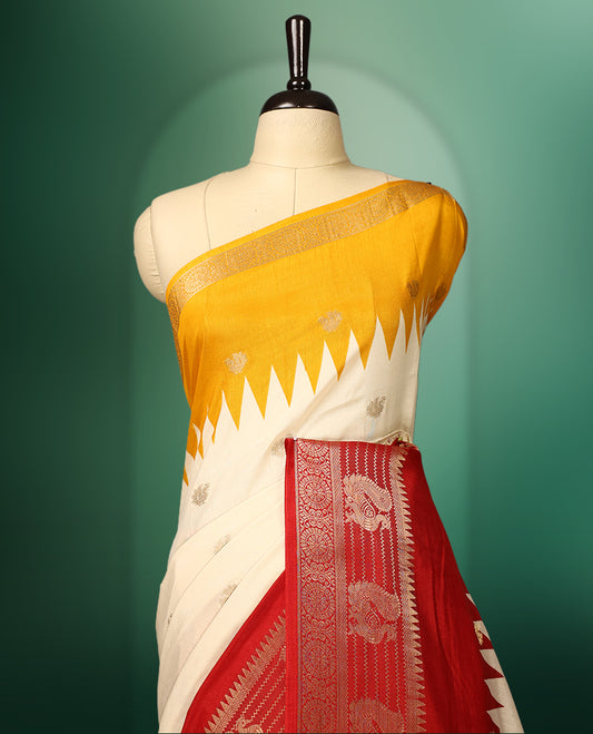 Cream and yellow colour saree featuring a rich red zari woven border and pallu, adorned with traditional floral motifs, and paired with a matching blouse