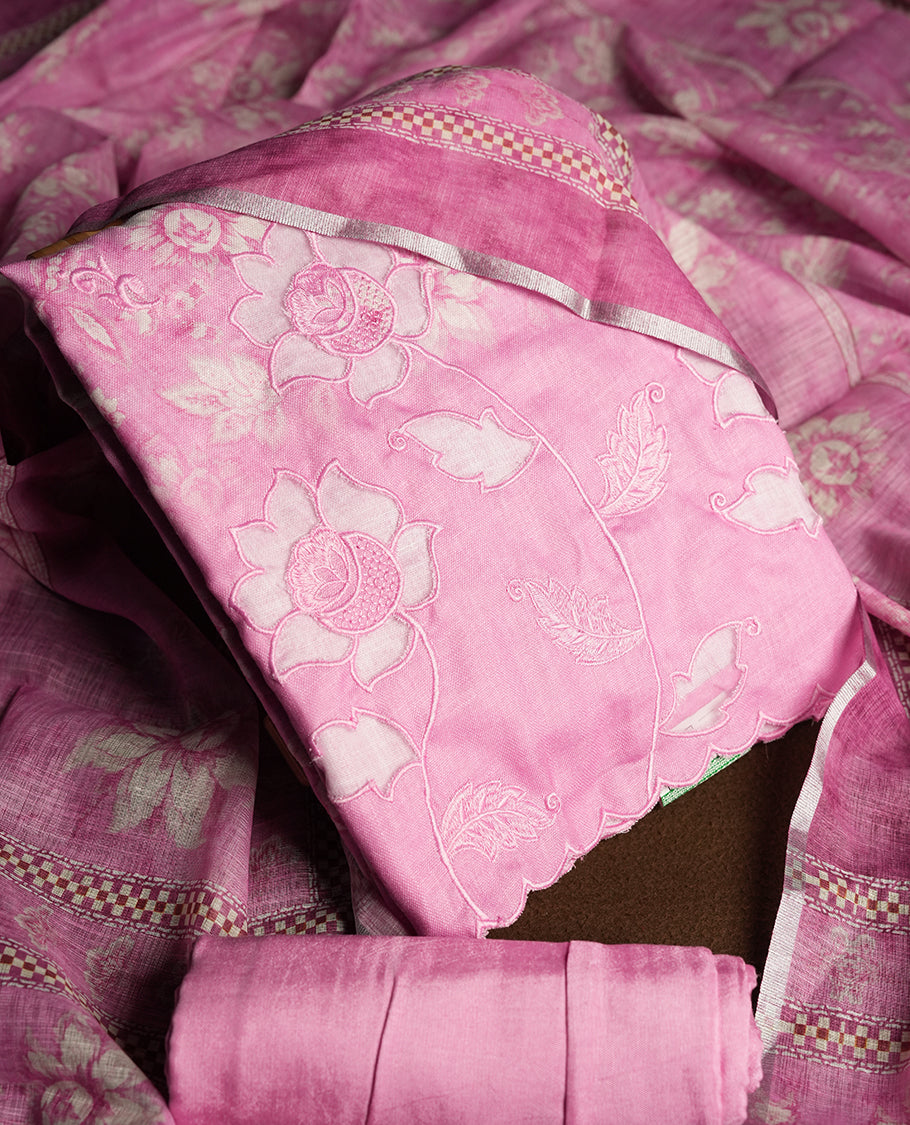 Pastel Magenta colour churidhar material featuring floral and cutwork embroidery on the front panel, digital floral printed dupatta with elegant border, and matching plain bottom.