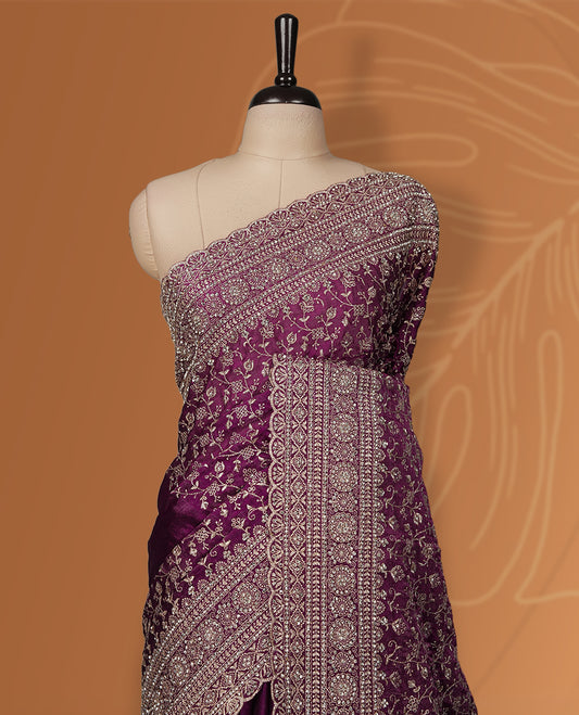 Magenta colour velvet chiffon designer saree in elegant two tone shades, featuring light gold zari, kodi work with handwoven style thread aari & dori embroidery work, Swarovski stone work and all over motifs, comes with matching blouse.