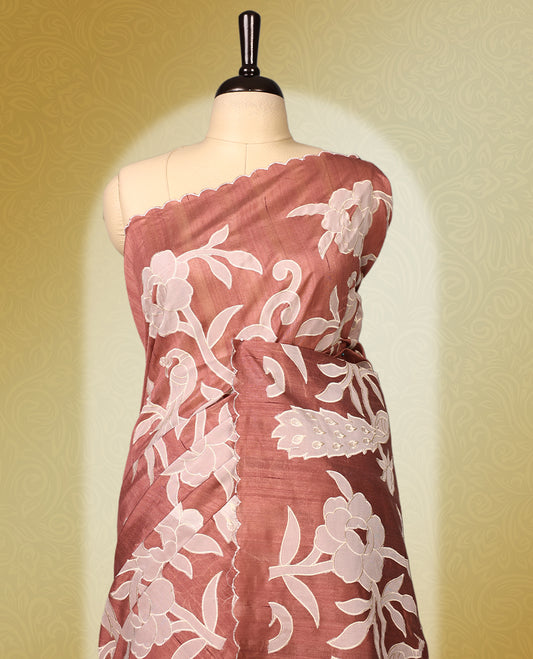 Mauve colour semi tussar saree adorned with elegant white applique work in leaf and floral designs across the body and border, paired with a matching blouse.