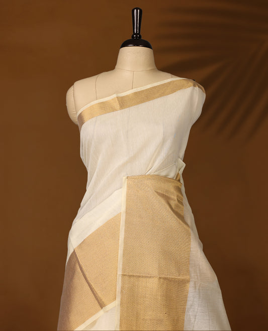 Elegant Off white colour Kerala saree with a traditional golden zari border and pallu, finished with golden tassels & A timeless ethnic piece, perfect for festivals and celebrations, paired with a matching blouse.