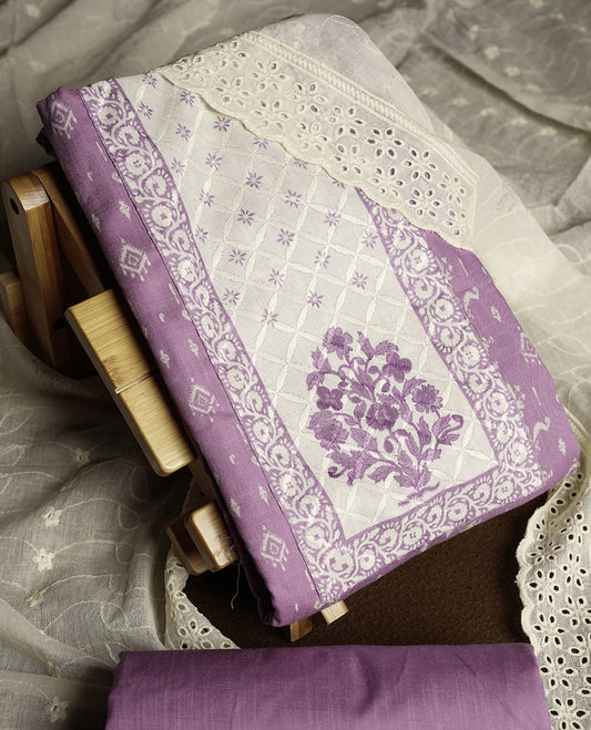 Pastel purple and off white colour churidar material featuring elegant thread work on the neckline and floral motifs on the body, dupatta is adorned with delicate embroidered motifs and scalloped lace border & Comes with a matching bottom.