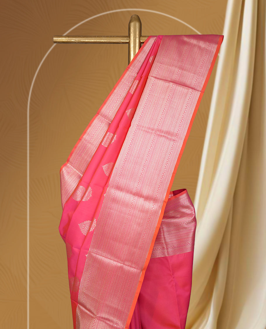 Pinkish peach colour body soft silk saree paired with a shimmering light peach & pink colour zari border & Adorned with elegant golden motifs and a matching blouse.