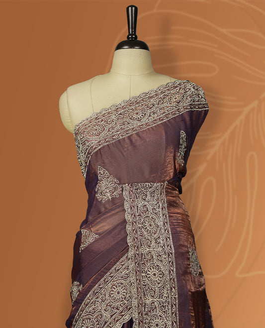 Double shaded Brown colour velvet chiffon designer saree in elegant two tone shades, featuring light gold zari, kodi work with handwoven style thread aari & dori embroidery work, Swarovski stone work and all over motifs, comes with matching blouse.