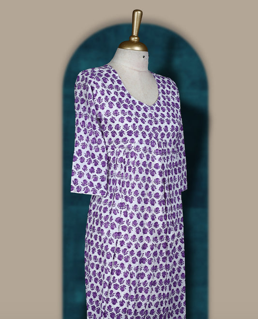Off white colour kurthi with purple floral block print, round neckline, and 3/4th sleeves & Perfect for casual wear or work from home comfort, Style with leggings or wear solo for a chic look.