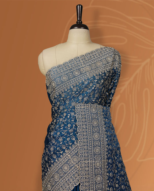 Royal blue colour velvet chiffon designer saree in elegant two tone shades, featuring light gold zari, kodi work with handwoven style thread aari & dori embroidery work, Swarovski stone work and all over motifs, comes with matching blouse.