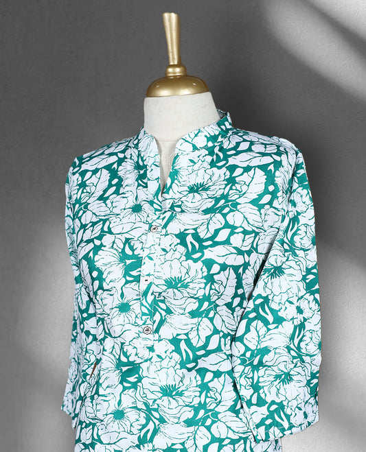 White and green colour cord set with bold floral prints, featuring a band collar top with front buttons and matching straight fit pants.