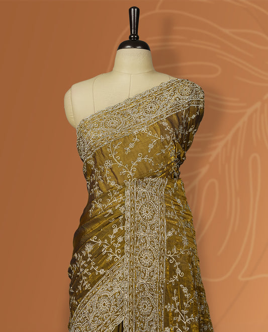 Mustard yellow colour velvet chiffon designer saree in elegant two tone shades, featuring light gold zari, kodi work with handwoven style thread embroidery, Swarovski stone work and all over motifs, comes with matching blouse.