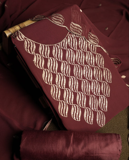 Dark Maroon colour churidar material adorned with intricate sequin embroidery on the neckline and body & dupatta comes with embroidered motifs and matching scalloped embroidered border & and plain bottom.