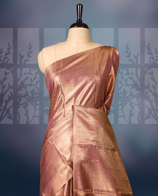 Golden pink colour semi silk brocade saree featuring delicate self brocade motifs across the body, enhanced with a soft gold toned woven border and pallu, Includes a matching blouse for a graceful ethnic look.