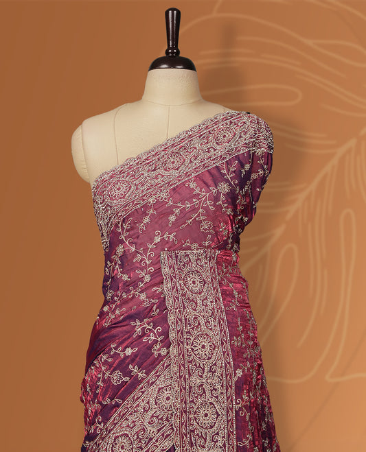 Purple colour velvet chiffon designer saree in elegant two tone shades, featuring light gold zari, kodi work with handwoven style thread embroidery, Swarovski stone work and all over motifs, comes with matching blouse.