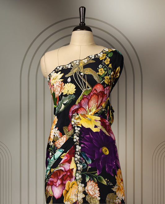 Black pure crepe saree featuring vibrant multi colour floral prints, adorned with delicate cut beads and pearl work along a scalloped border, paired with a matching blouse.