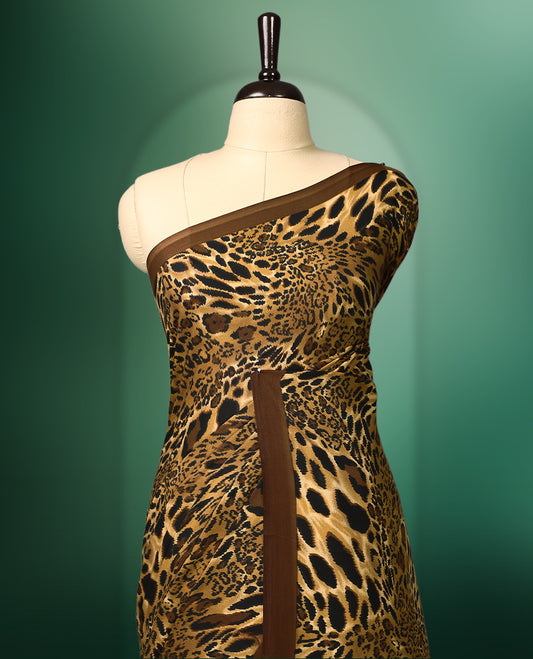 Brown colour semi modal silk saree with a striking leopard print across the body, complemented by a deep brown plain border, and paired with a matching blouse
