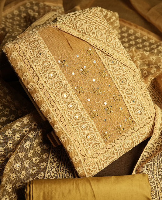 Golden Beige colour churidar material featuring intricate thread embroidery with mirror & cut beads work on the front panel, paired with an all over embroidered net dupatta and matching bottom.