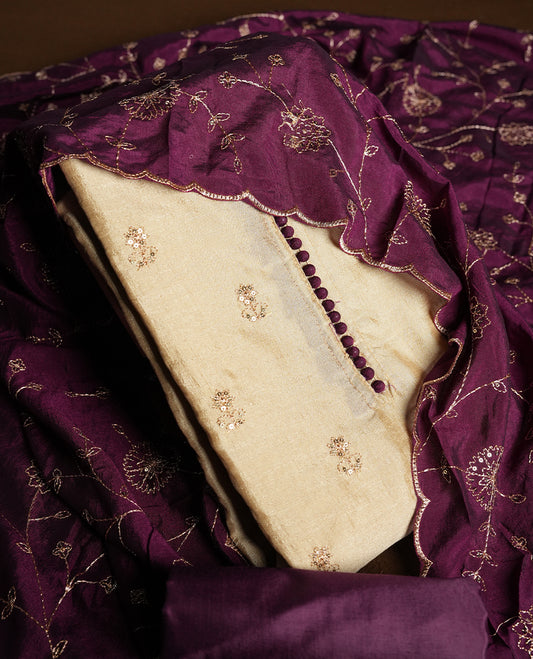 Golden Cream colour churidhar material featuring thread embroidery on the front panel, contrast Dark Purple colour dupatta with elegant border, and matching plain bottom